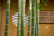 Japanese bamboo stems and traditional circular window with washi and bamboo lattice screen