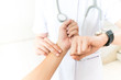 Nurse taking  the patient's pulse hand on white background
