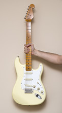 Hand Holding White Vintage Electric Guitar
