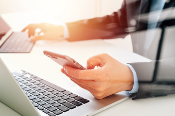 Poster - Hands of businessman using mobile phone in modern office with laptop and digital tablet computer with VR icon diagram