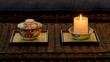 Candle and Japanese Arita porcelain ceramics on lacquer trays