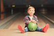 © Africa Studio - Cute child with ball in bowling club