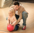 © Africa Studio - Family having fun at bowling club