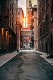 Fototapeta Nowy York - Red bricks building at New York City street at sunset time.