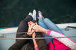 Couple sitting on sailboat and holding hand. Engagement photo. Love story
