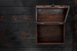 Old open chest close up on dark wooden table