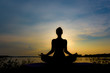 © Chayanin Wongpracha - Silhouette beautiful women yoga in nature on the rock and river over sunset background.