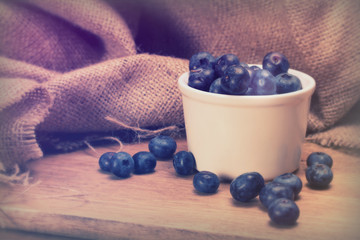 Wall Mural - Pot of blueberries on a rustic background