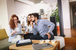 © BalanceFormCreative - Female Real Estate agent offer home ownership and life insurance to young couple.