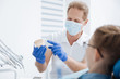 © zinkevych - Skillful experienced dentist giving his patient a lecture