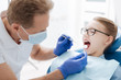 © zinkevych - Skillful dentist checking a general condition of his patient