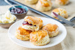 English Pastries, Scones with Raspberry Jam on Rustic Table, Horizontal View