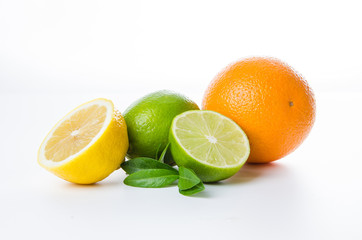 Wall Mural - Composition of lemon orange and lime and mint leaves