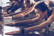 © LIGHTFIELD STUDIOS - group of athletic young people in sportswear stretching at the gym, group fitness concept