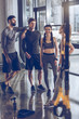 © LIGHTFIELD STUDIOS - group of athletic young people in sportswear standing and resting at the gym, group fitness concept