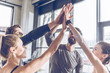 © LIGHTFIELD STUDIOS - Happy young athletic people in sportswear giving high five in gym