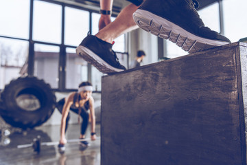 Wall Mural - Close-up partial view of sporty people exercising at cross fit gym workout