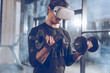 © LIGHTFIELD STUDIOS - side view of man in virtual reality headset exercising with dumbbells in gym