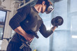 © LIGHTFIELD STUDIOS - side view of man in virtual reality headset exercising with dumbbells in gym