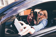 © F8  \ Suport Ukraine - Side view of four beautiful young cheerful women making selfie and smiling while sitting in car together