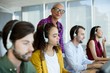 © WavebreakMediaMicro - Customer service executive trainer monitoring her team
