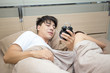 © Jestercine - Man holding alarm clock on morning with woman, 20-30 year old.