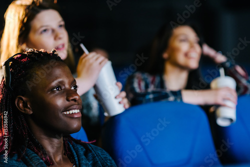 Fotografie, Tablou Black woman enjoying a sweet romantic comedy at the movies