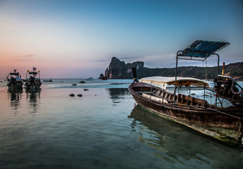 Naklejka na meble KO PHI PHI, THAILAND, January 31, 2014: Traditional long tail boats on the beach at sunset, Ko Phi Phi, Andaman Sea, famous tourist destination in Thailand