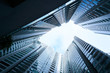 © jamesteohart - Abstract low angle view of common modern business skyscrapers.Multistoried modern and stylish living block of flats. Real estate and new house.