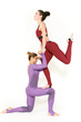 © Nestor - Support is crucial. Vertical shot of two beautiful female gymnasts posing together one supporting another as she is balancing
