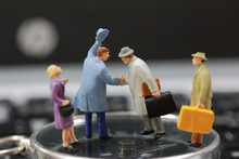 Selective Focus Of Miniature Tourist Handshake As Welcome And Travel Concept.