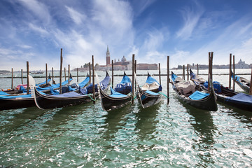  Venice. A sunset over the channel Grande and gondolas at the mooring..