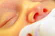 © Voyagerix - Closeup of little newborn sleeping with teat in mouth