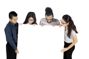 Wall Mural - Business team looking at a blank banner