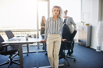 Wall Mural - Business woman standing in front of team