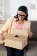 © Syda Productions - happy young indian woman with parcel box at home