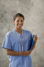 Portrait Of A Smiling Young Nurse Holding A Clipboard.