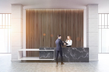 Wall Mural - Black marble reception, wood blinds, people