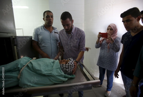 Palestinians Look At The Body Of 13 Year Old Boy Abdel