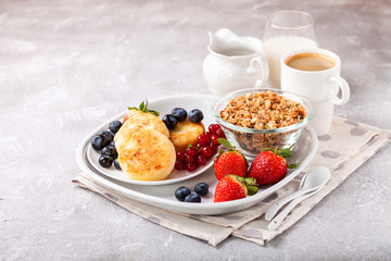 Wall Mural - Cottage cheese pancakes with berries. Selective focus. Russian cheesecakes. Copy space