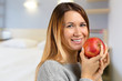 © fotofabrika - Smiling woman holding red apple