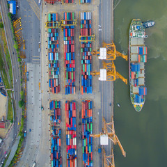 Wall Mural - Top view of container ship unloading in port