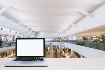 Wall Mural - Laptop with blank screen on table with work space area blurred background for concept technology 4.0; work every place; co worker.