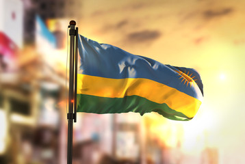 Sticker - Rwanda Flag Against City Blurred Background At Sunrise Backlight