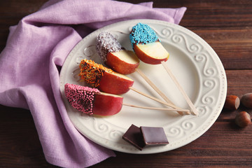 Sticker - Plate with candied apple wedges on wooden background