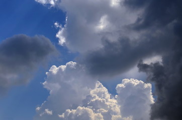 white and a dark cloud on a blue sky, background