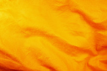 An Orange Plastic Background. Orange Background For Manufacturers Of Plastic Products. Close-up Of A Texture Of Pimply Polypropylene For The Background Of The Art