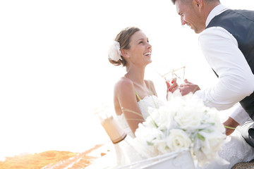 Wall Mural - Happy bride and groom celebrating wedding with champagne