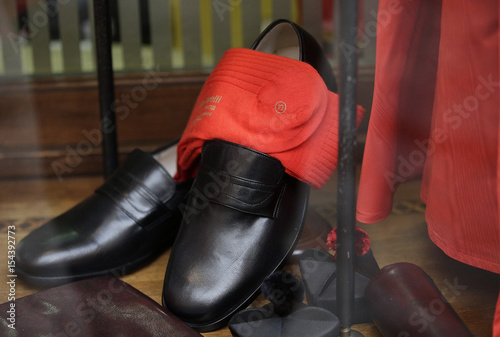 Shoes And Socks For A Cardinal Are Seen On Display At The Window