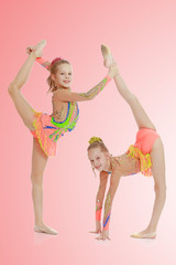 Two girls gymnast sitting on splits.